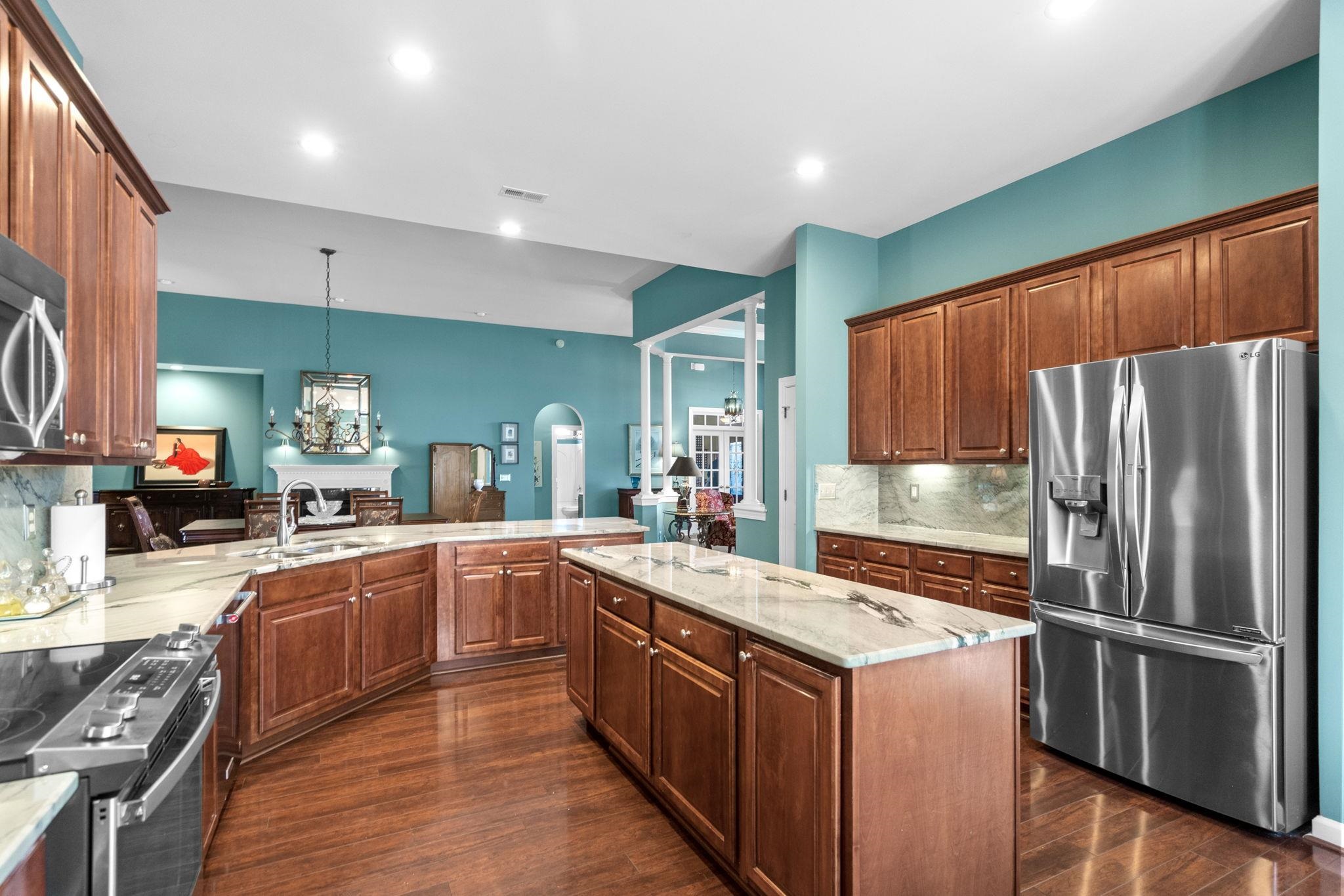 699 Bullrush Court Calabash, NC 28467 - Photo 9 of 40 Kitchen with stainless steel appliances, decorative backsplash, brown cabinets, a peninsula, and recessed lighting