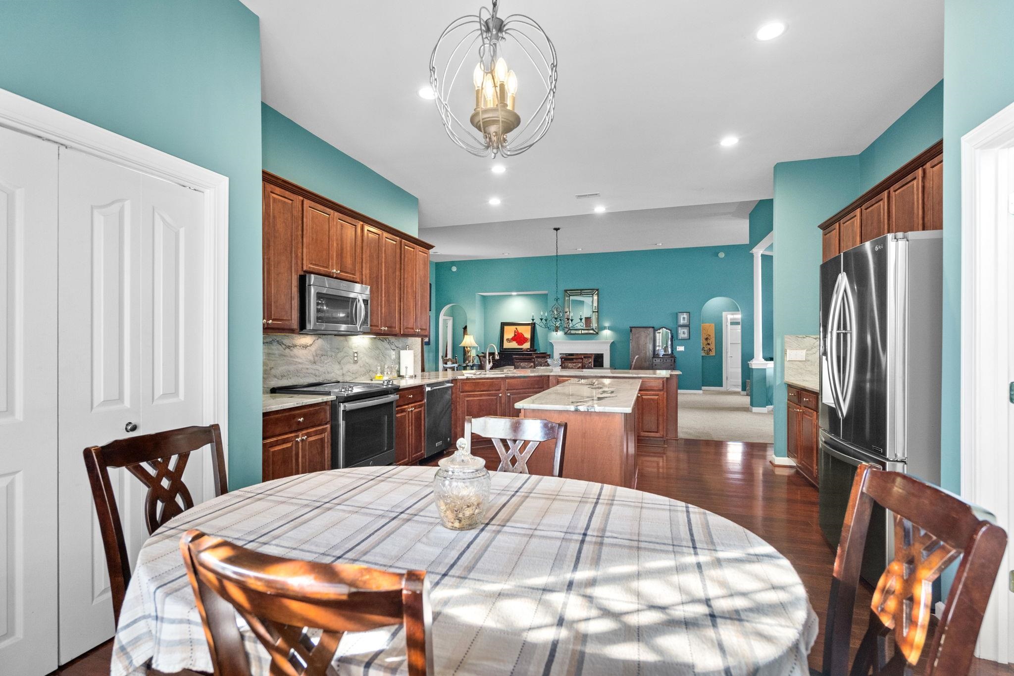 699 Bullrush Court Calabash, NC 28467 - Photo 10 of 40 Kitchen featuring pendant lighting, arched walkways, a peninsula, stainless steel appliances, and a chandelier