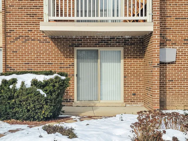 a view of a house with snow on the road