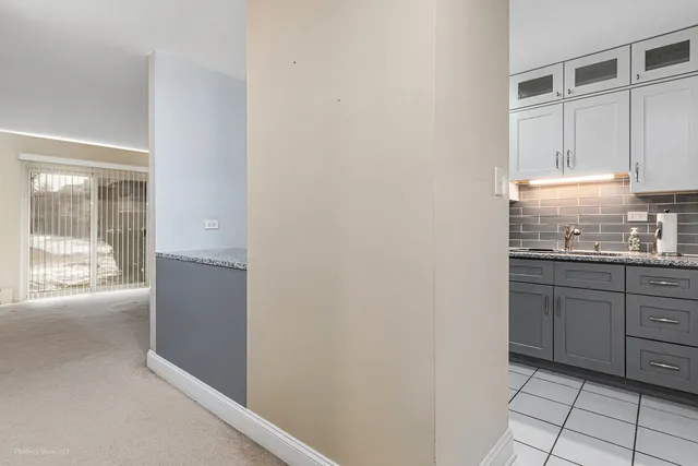 a kitchen with granite countertop white cabinets and white appliances