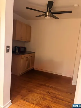 a view of a hallway with wooden floor and entryway