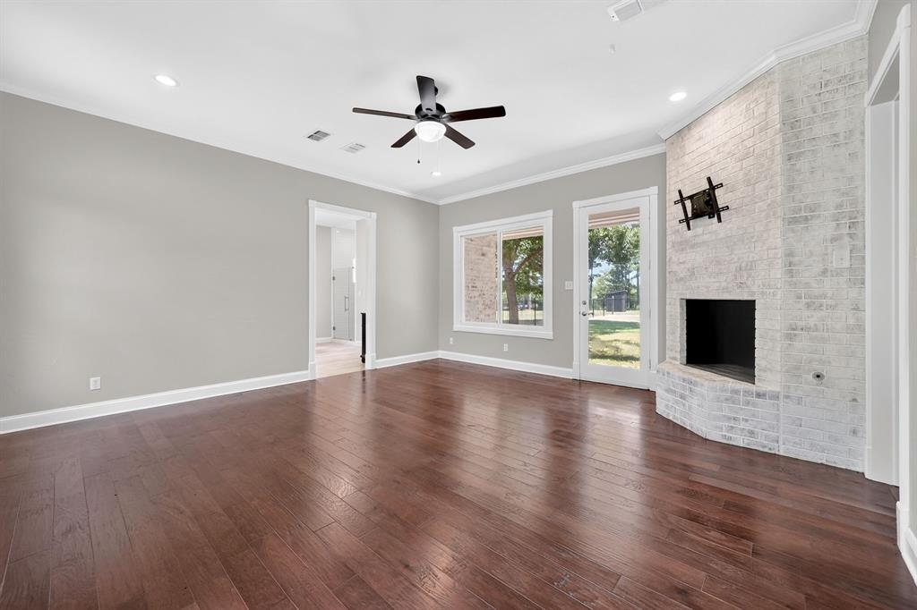 1201 Robbins Road Athens, TX 75751 - Photo 20 of 40 1st Floor- Primary Ensuite featuring a brick, wood burning fireplace. Exit Door for exclusive access to fenced backyard.