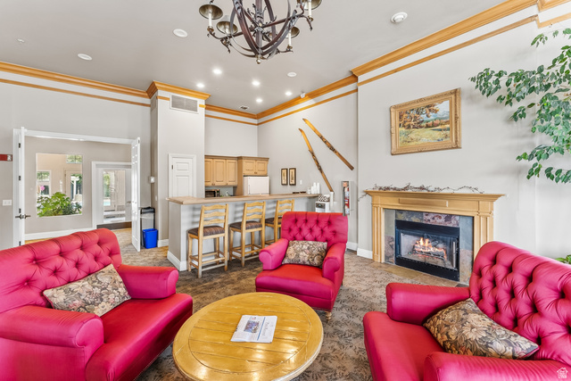 900 Bitner Road, Unit K25 Park City, UT 84098 - Photo 29 of 35 Spacious common area featuring a built-in fireplace with stone surround, a full-service bar with light wood cabinetry, and recessed lighting throughout
