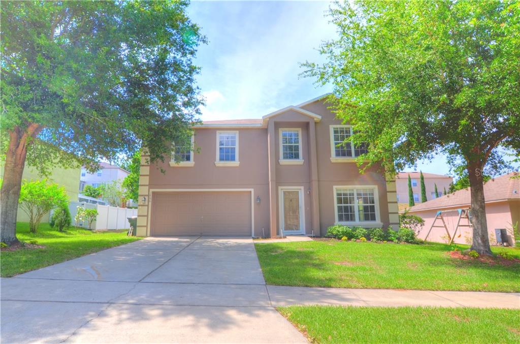 1866 Ridge Valley Street Clermont, FL 34711 - Photo 1 of 1 a front view of a house with a yard and garage