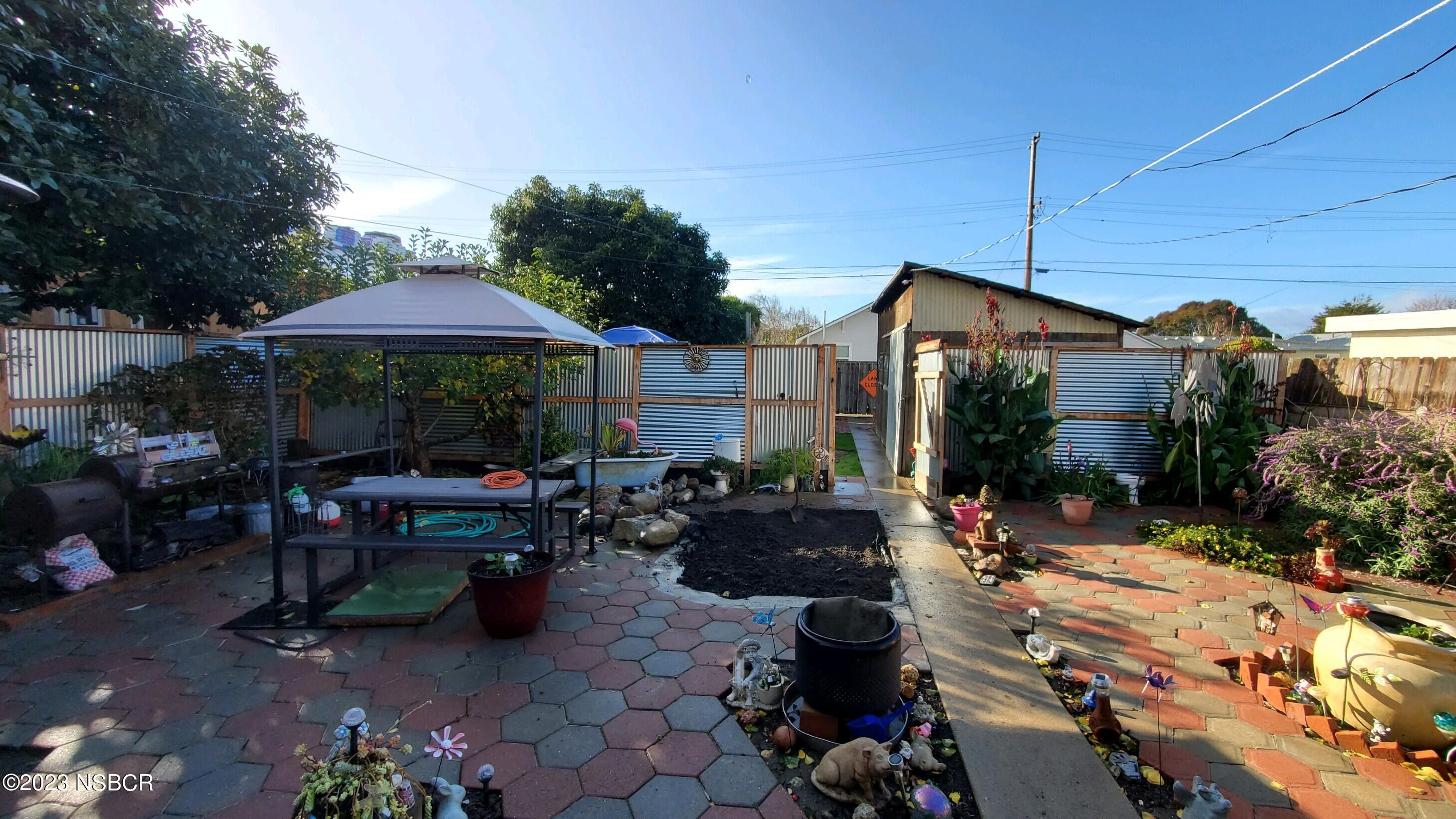 233 South E Street Lompoc, CA 93436 - Photo 14 of 17 a view of patio with a table and chairs under an umbrella