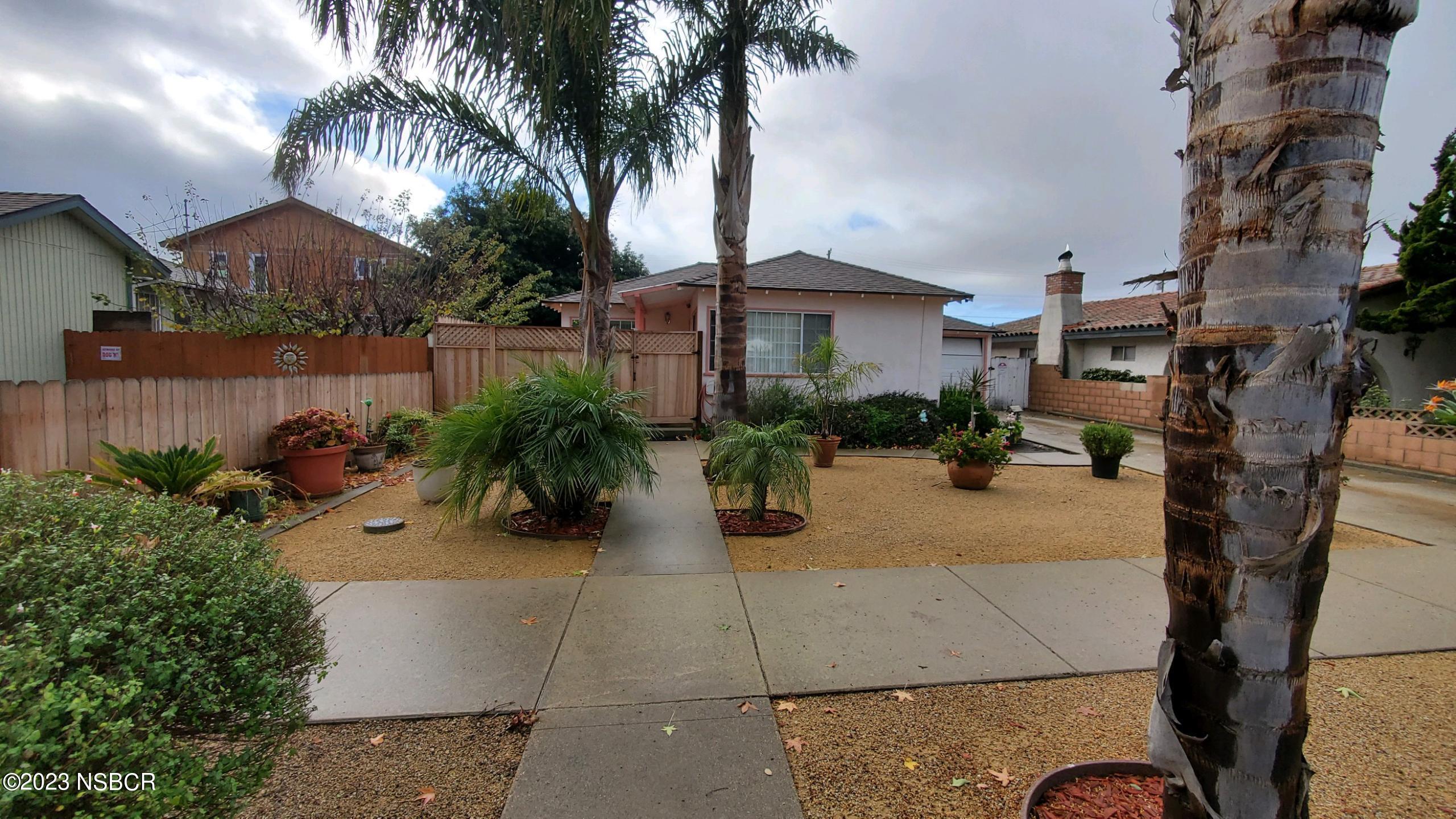 233 South E Street Lompoc, CA 93436 - Photo 2 of 17 a view of multiple house with potted plants