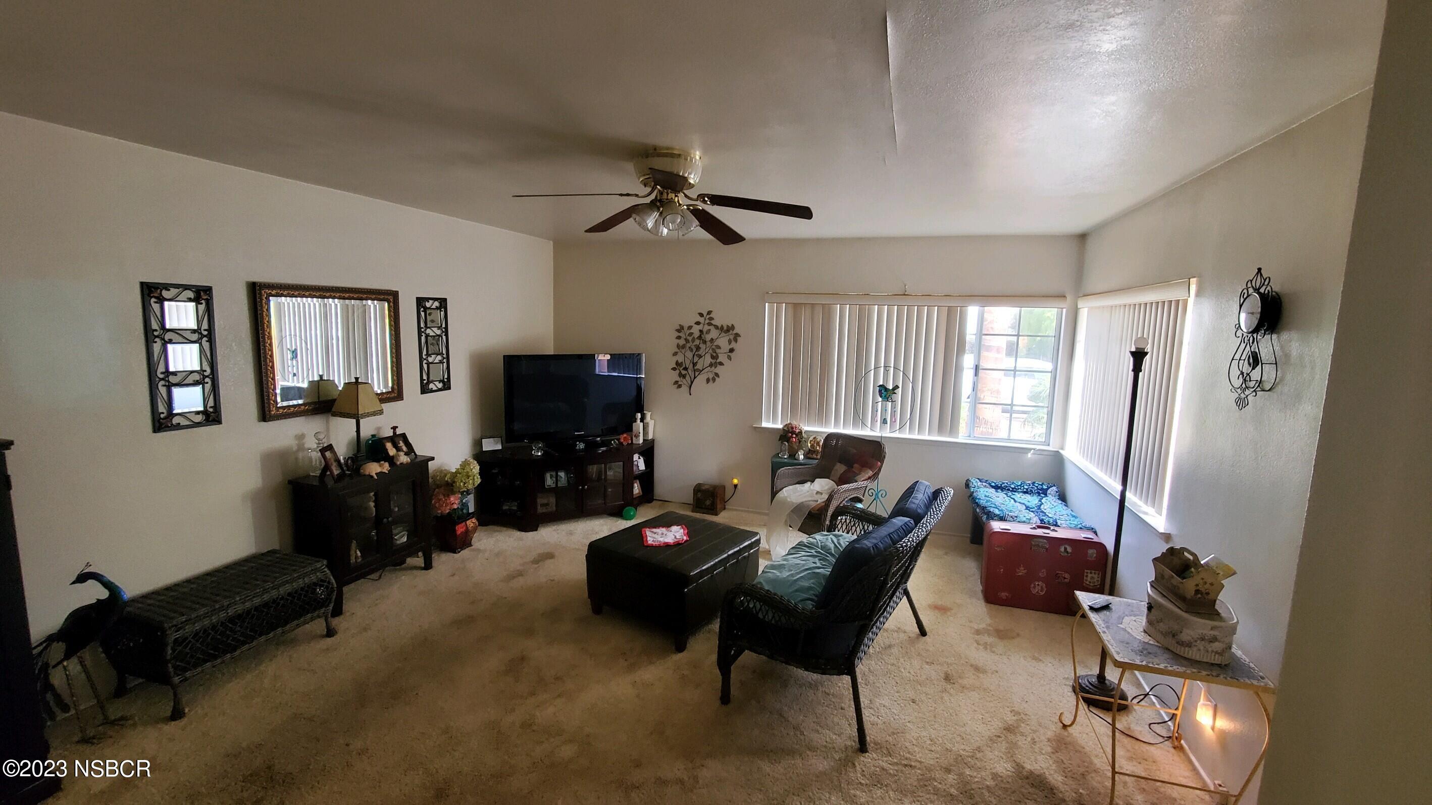 233 South E Street Lompoc, CA 93436 - Photo 3 of 17 a living room with furniture and a flat screen tv