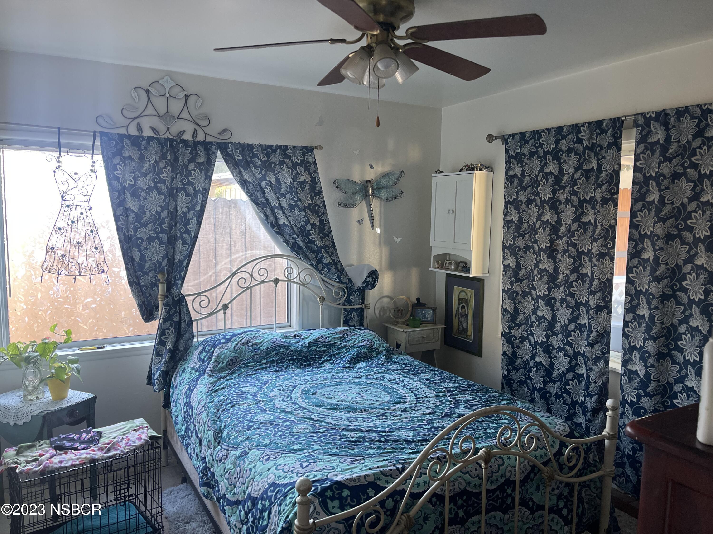 233 South E Street Lompoc, CA 93436 - Photo 4 of 17 a bed sitting in a bedroom next to a window