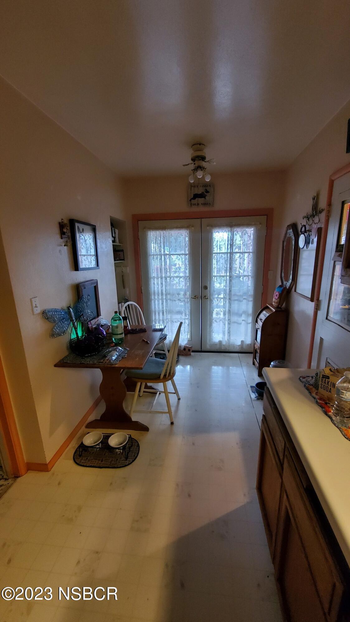 233 South E Street Lompoc, CA 93436 - Photo 9 of 17 a living room with furniture a piano and a window