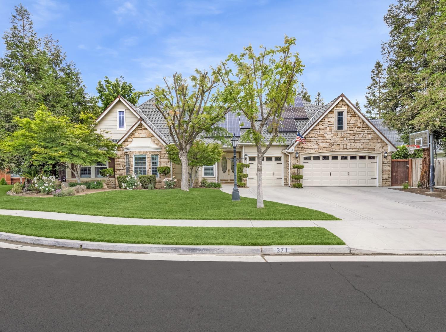 371 West Warwick Avenue Clovis, CA 93619 - Photo 1 of 42 a view of white house with a big yard and large trees