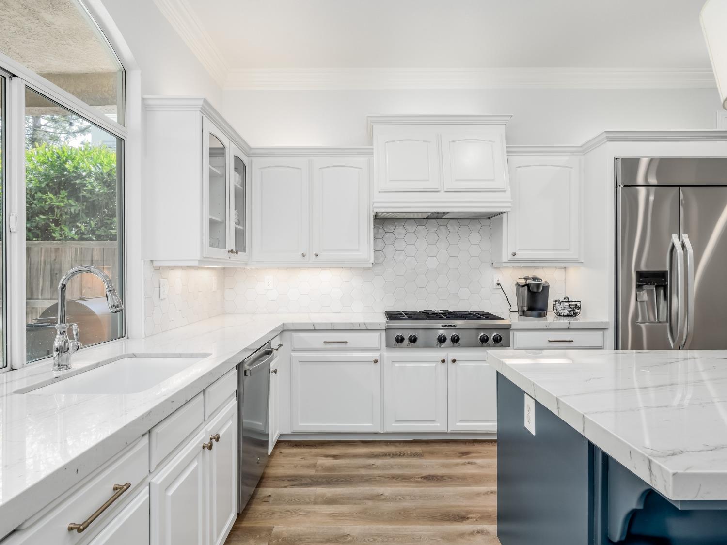 371 West Warwick Avenue Clovis, CA 93619 - Photo 14 of 42 a kitchen with stainless steel appliances granite countertop a sink stove and refrigerator