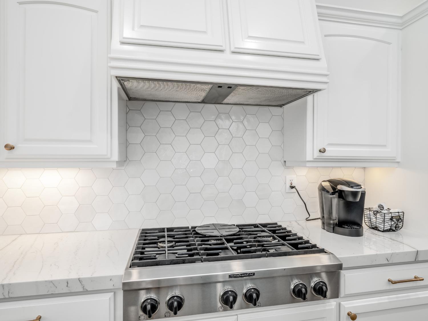 371 West Warwick Avenue Clovis, CA 93619 - Photo 15 of 42 a kitchen with white cabinets and a stove top oven