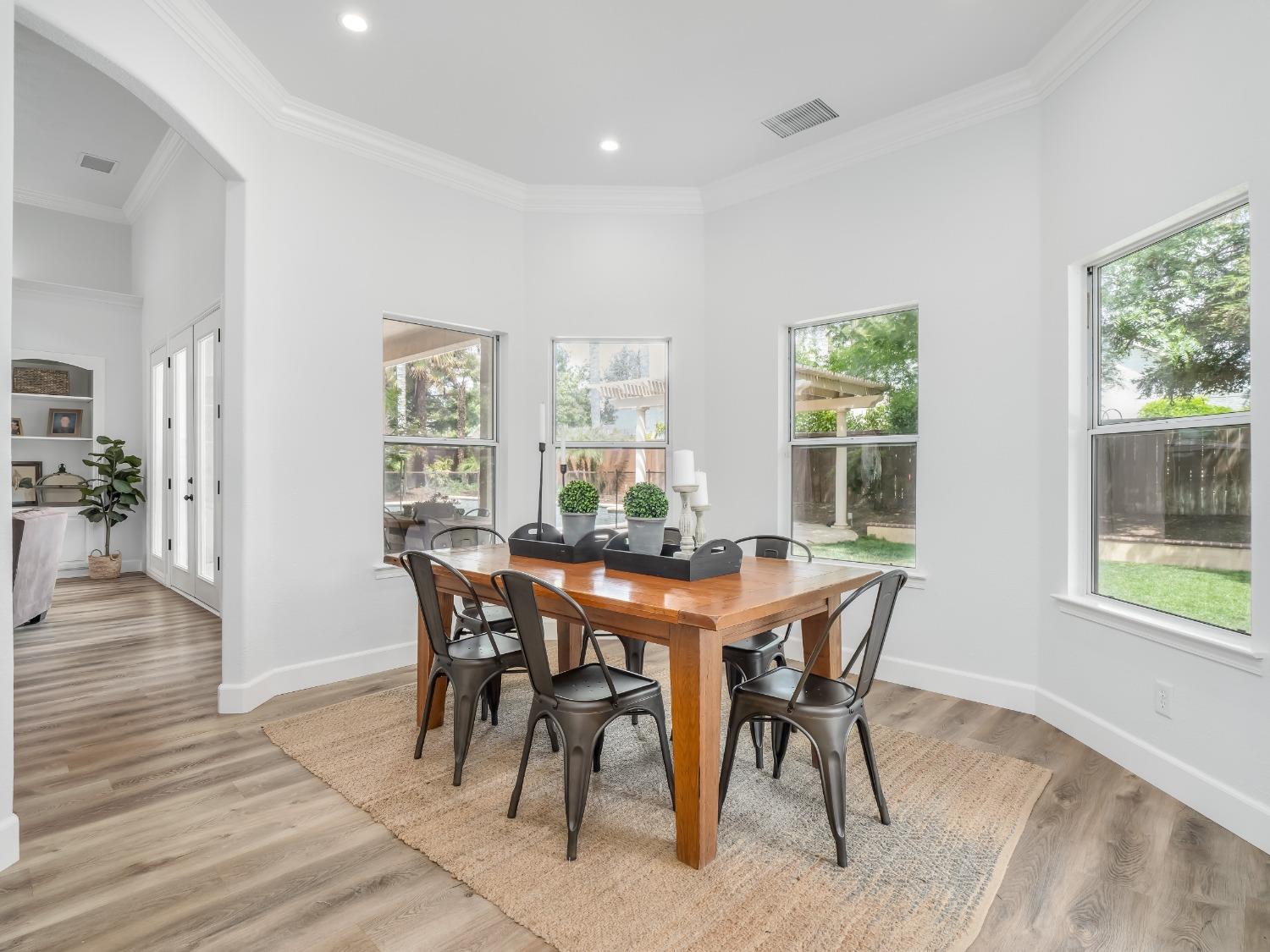 371 West Warwick Avenue Clovis, CA 93619 - Photo 18 of 42 a view of a dining room with furniture and wooden floor
