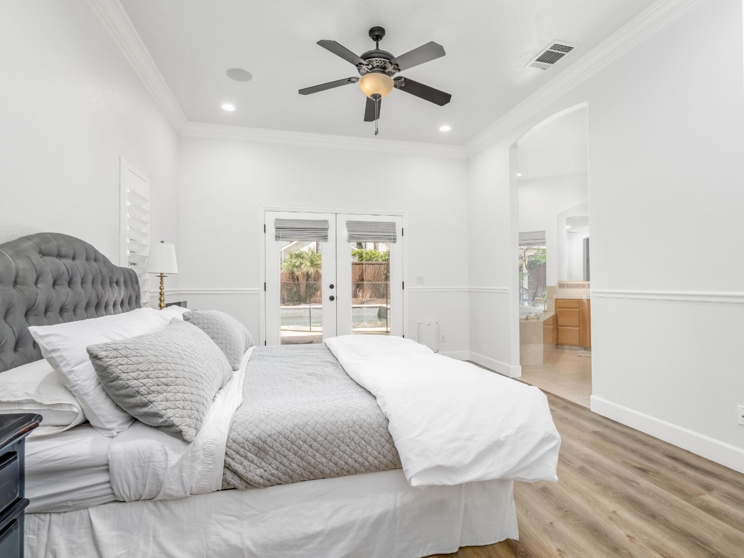 371 West Warwick Avenue Clovis, CA 93619 - Photo 20 of 42 a spacious bedroom with a bed and ceiling fan