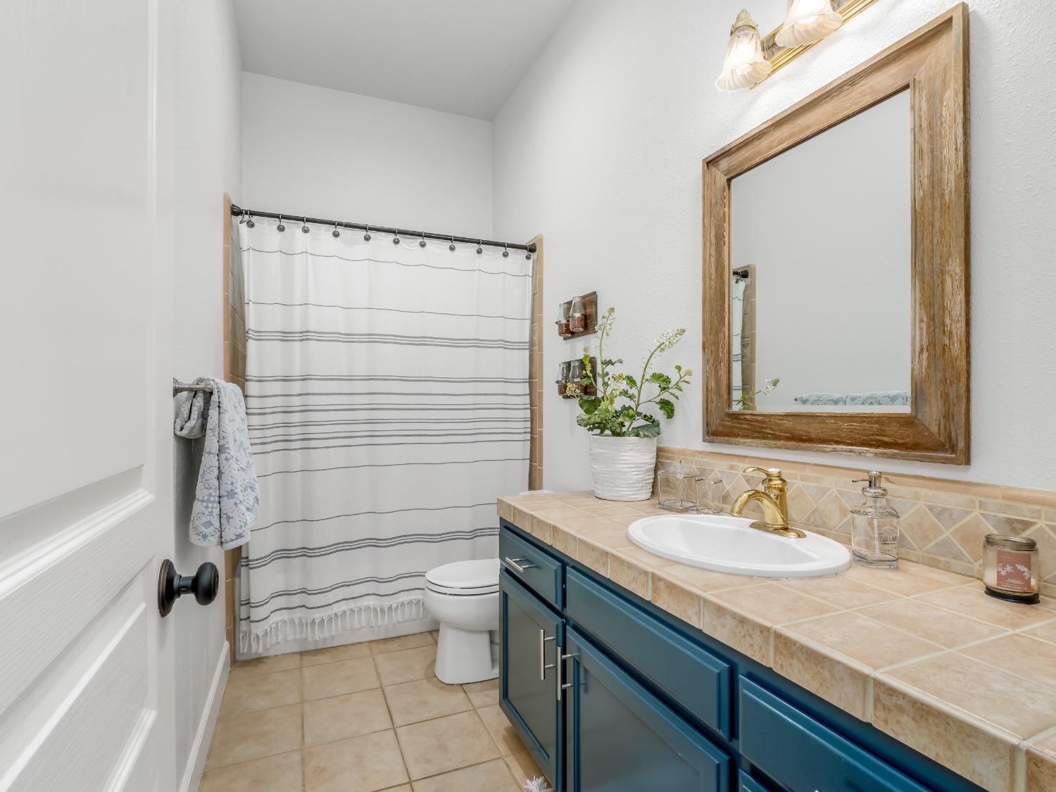 371 West Warwick Avenue Clovis, CA 93619 - Photo 27 of 42 a bathroom with a granite countertop sink toilet and shower