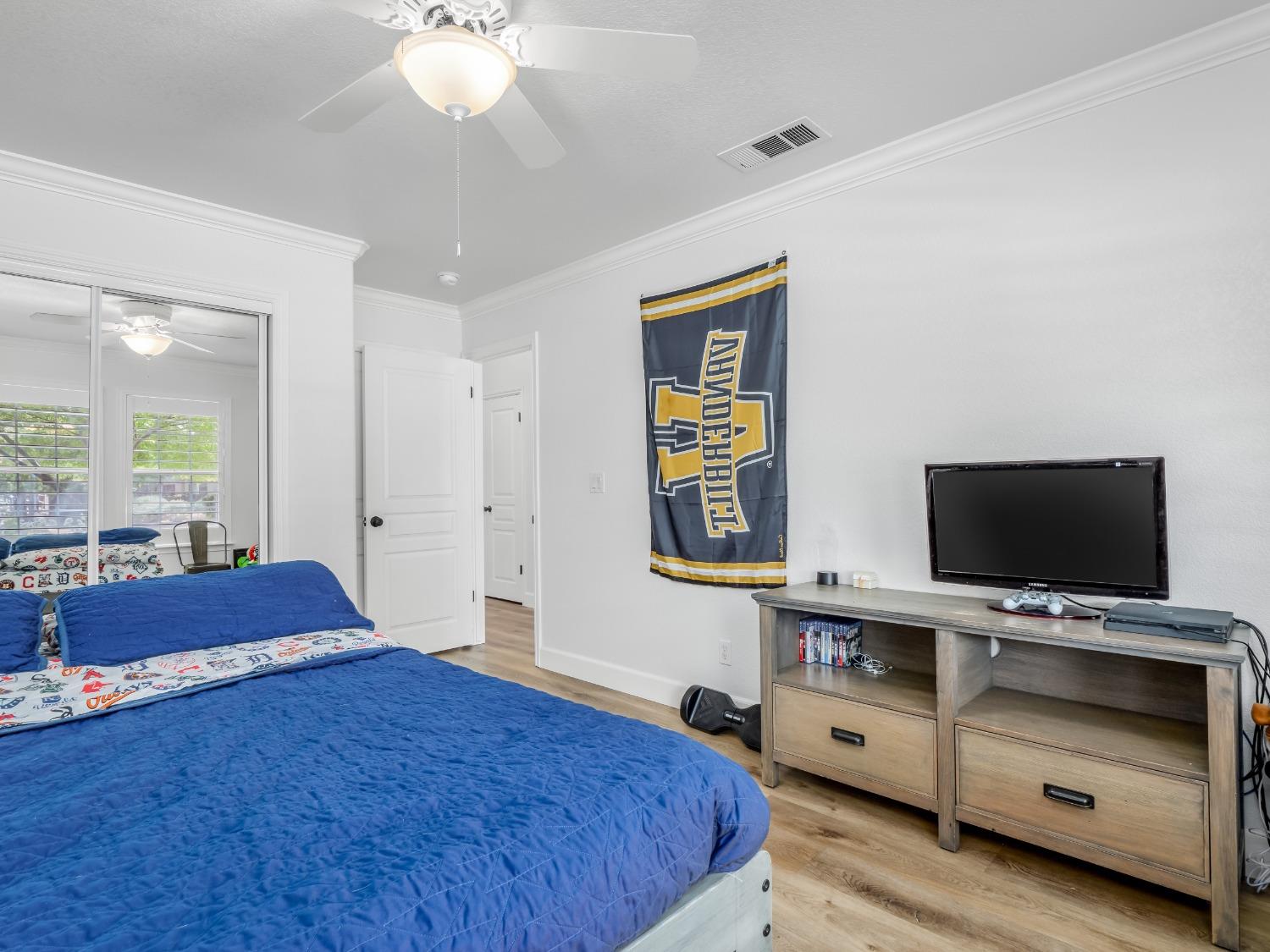 371 West Warwick Avenue Clovis, CA 93619 - Photo 29 of 42 a bedroom with a bed and a flat screen tv