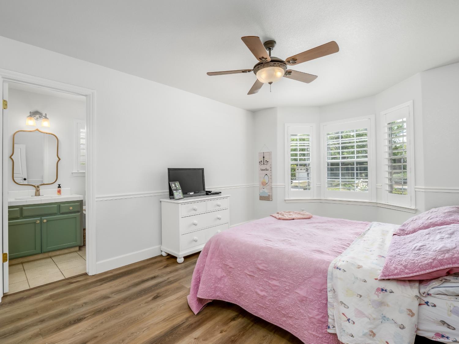 371 West Warwick Avenue Clovis, CA 93619 - Photo 30 of 42 a bedroom with a bed and a flat screen tv