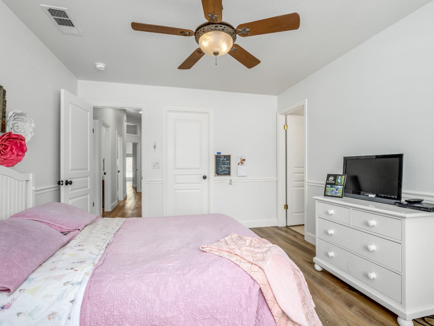 371 West Warwick Avenue Clovis, CA 93619 - Photo 31 of 42 a bedroom with a bed and a flat screen tv