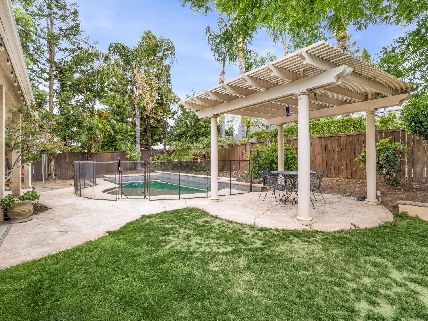 371 West Warwick Avenue Clovis, CA 93619 - Photo 38 of 42 a view of a patio with table and chairs under an umbrella