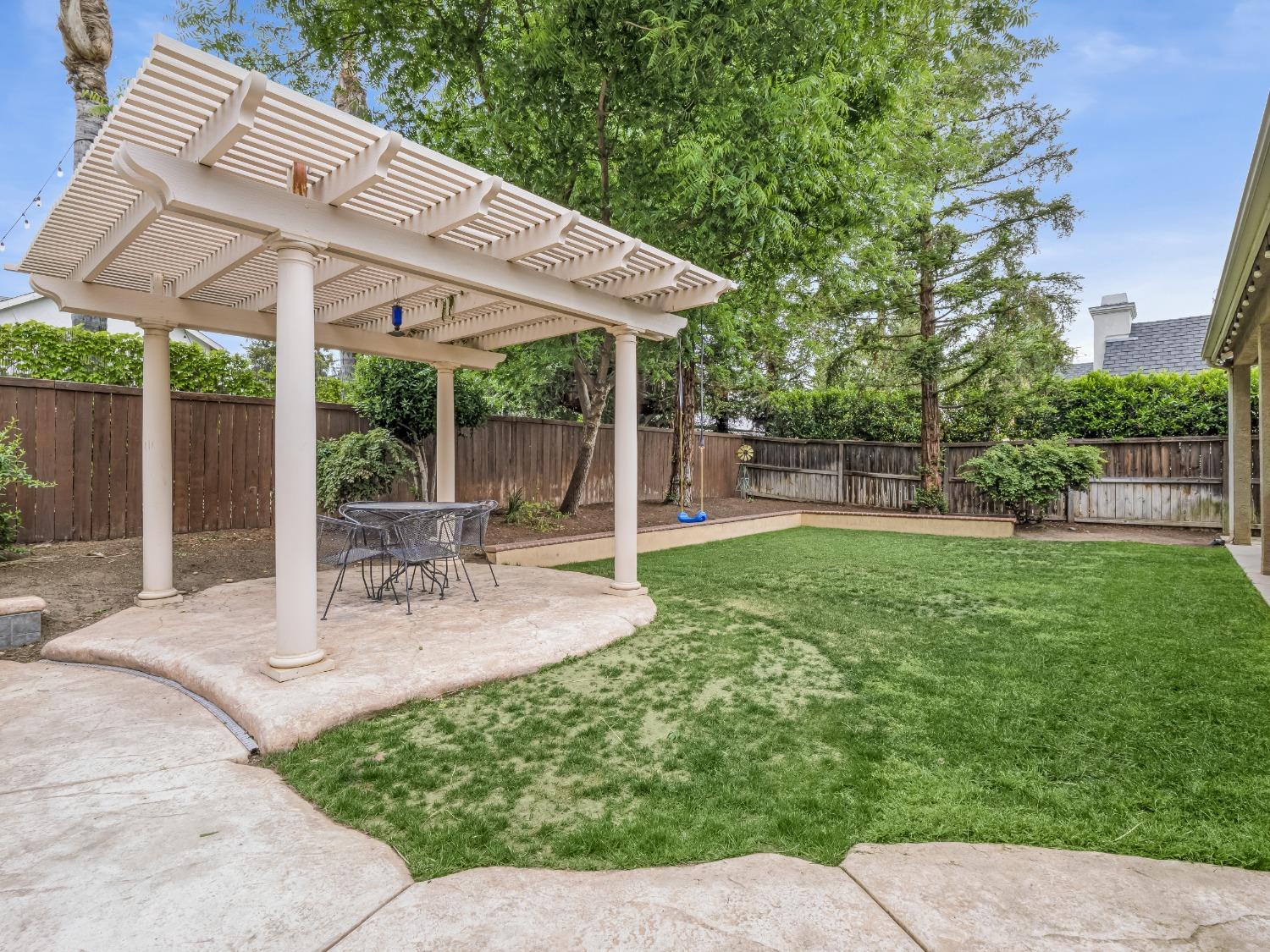371 West Warwick Avenue Clovis, CA 93619 - Photo 42 of 42 a view of a patio with a table chairs and a backyard