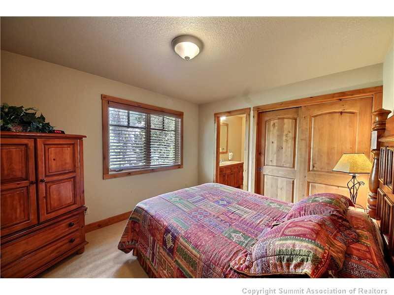 18 Rasor Drive, Unit 18 Keystone, CO 80435 - Photo 11 of 18 a bedroom with a bed and wooden cabinets