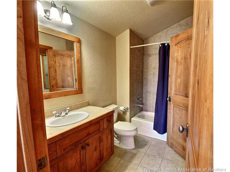 18 Rasor Drive, Unit 18 Keystone, CO 80435 - Photo 15 of 18 a bathroom with a granite countertop sink toilet and shower