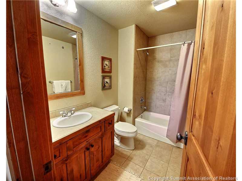 18 Rasor Drive, Unit 18 Keystone, CO 80435 - Photo 16 of 18 a bathroom with a granite countertop sink toilet and shower