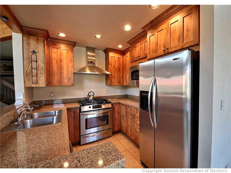 18 Rasor Drive, Unit 18 Keystone, CO 80435 - Photo 5 of 18 a kitchen with stainless steel appliances granite countertop a refrigerator a stove and a sink
