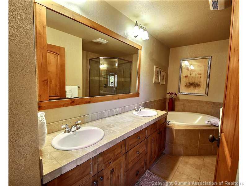 18 Rasor Drive, Unit 18 Keystone, CO 80435 - Photo 9 of 18 a bathroom with a double vanity sink and a mirror