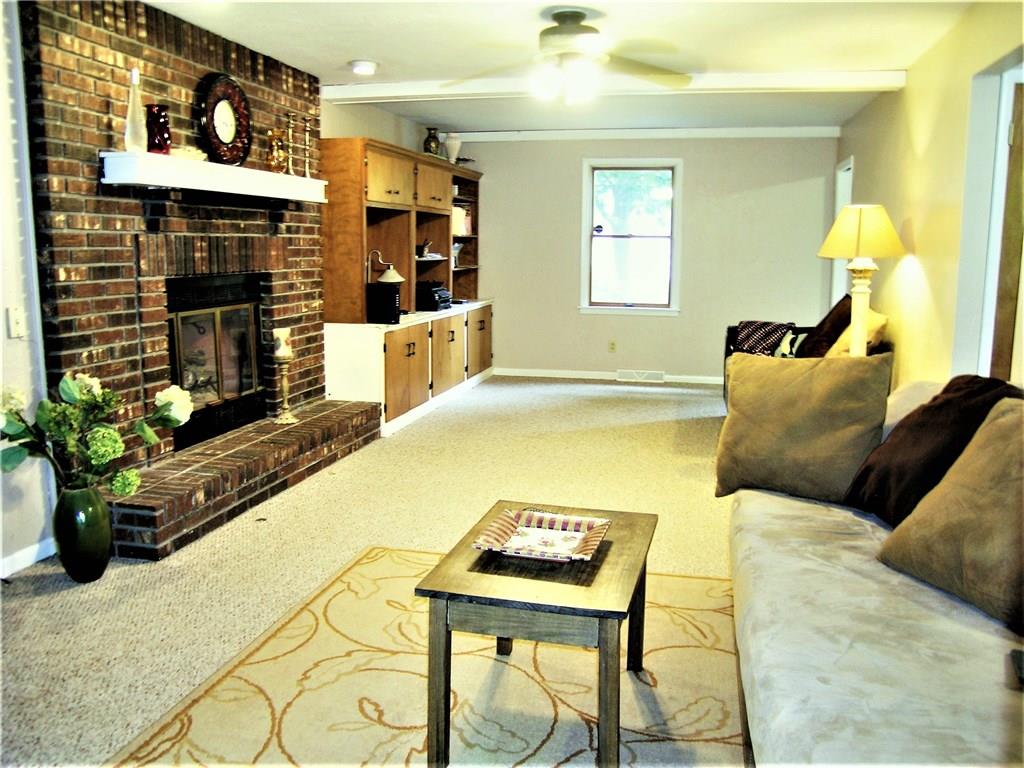 325 Inwood Road Pittsburgh, PA 15237 - Photo 5 of 19 Large Family Room with Masonary Fireplace, gas starter ,ceiling fan with overhead lighting. Built in cabinetry and box beam ceiling create additional character to the room !Neutral dcor!
