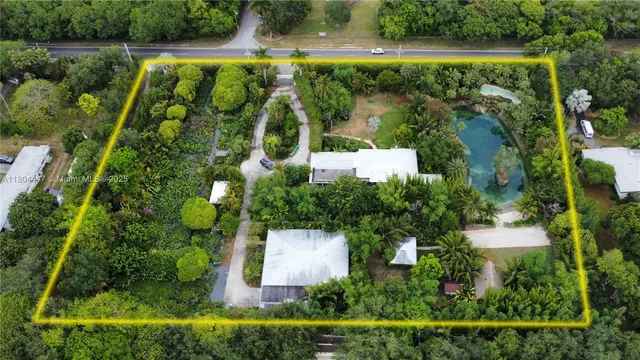 an aerial view of residential house with outdoor space and swimming pool