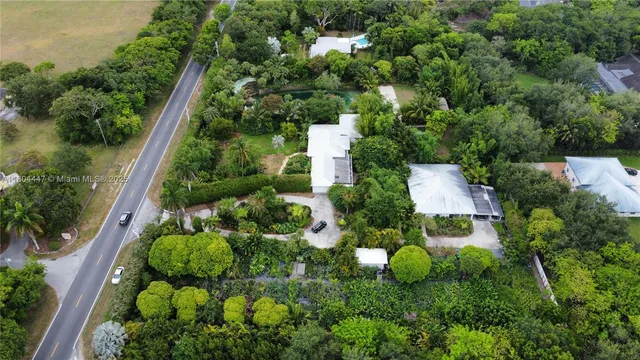 an aerial view of residential house with outdoor space and swimming pool