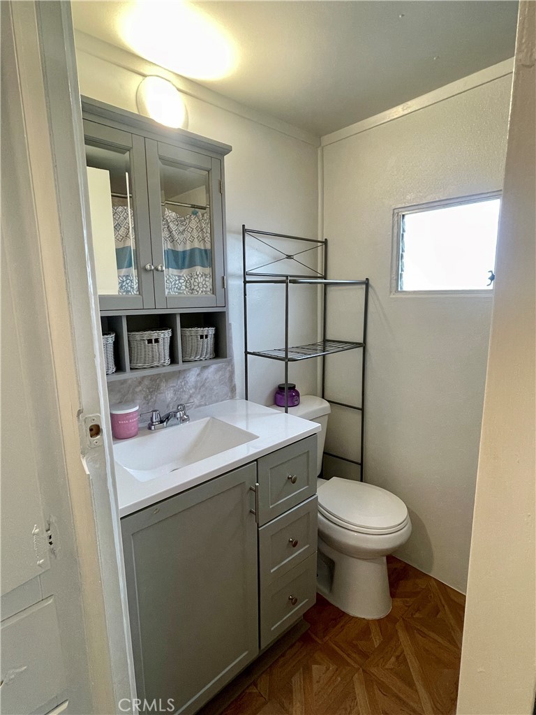 12995 6th Street Yucaipa, CA 92399 - Photo 9 of 13 a bathroom with a sink toilet and shower