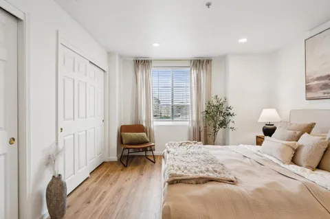 a bedroom with a bed and a chair