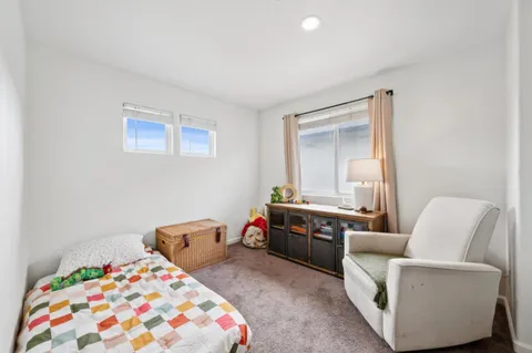 a bedroom with furniture and windows