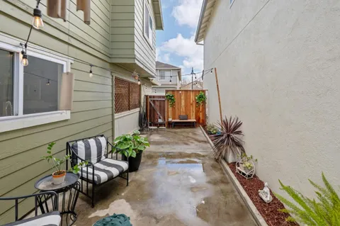 a view of a patio with table and chairs potted plants with wooden floor