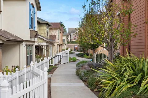 a view of a house with wooden fence