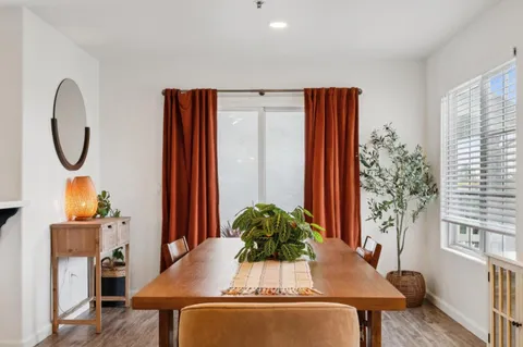 a view of a dining room with furniture and a potted plant