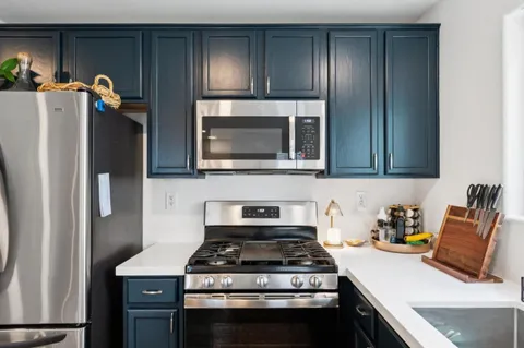 a kitchen with stainless steel appliances granite countertop a stove and a refrigerator