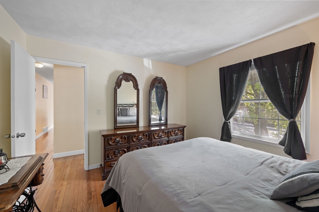85 Tower Street Hudson, MA 01749 - Photo 13 of 25 a bedroom with a bed a mirror and a window