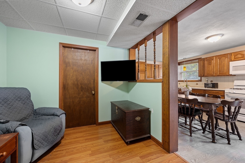 85 Tower Street Hudson, MA 01749 - Photo 20 of 25 a living room with furniture a flat screen tv and kitchen view