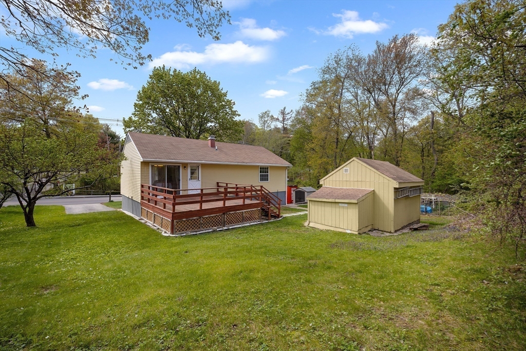 85 Tower Street Hudson, MA 01749 - Photo 23 of 25 a view of a white house with a big yard and large trees