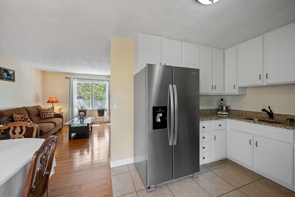 85 Tower Street Hudson, MA 01749 - Photo 5 of 25 a kitchen with stainless steel appliances granite countertop a refrigerator sink and cabinets