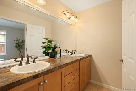 a bathroom with a double vanity sink and a mirror