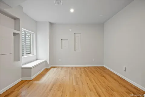 a view of room with window and wooden floor