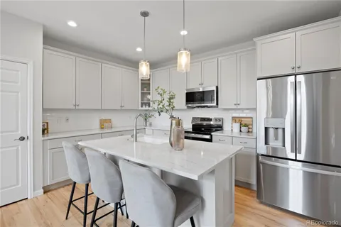 a kitchen with stainless steel appliances a refrigerator stove microwave and cabinets