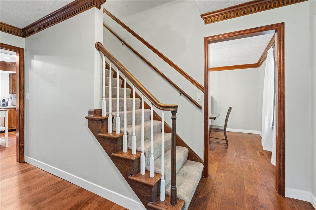 10168 Atchison Road Dayton, OH 45458 - Photo 16 of 44 This interior features a wooden staircase, hardwood floors, and a well-defined entryway.