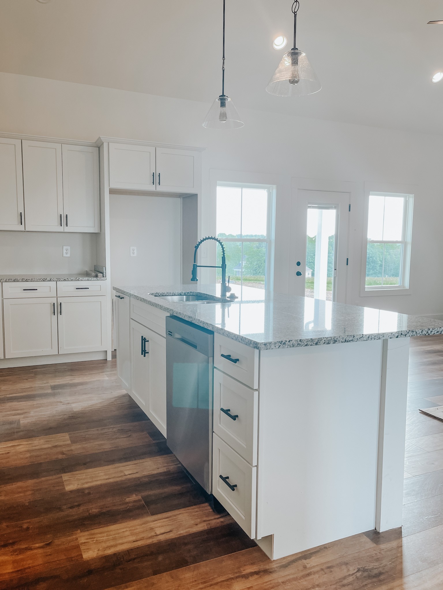 1402 Fowler Ford Road Portland, TN 37148 - Photo 12 of 27 a kitchen with granite countertop a sink cabinets and wooden floor