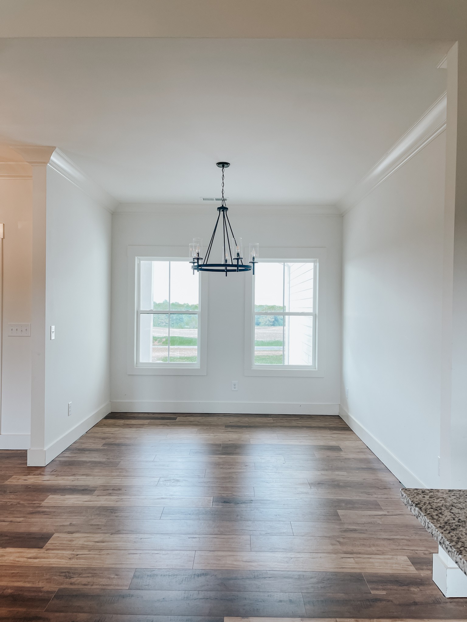 1402 Fowler Ford Road Portland, TN 37148 - Photo 15 of 27 a view of an empty room with wooden floor and a window