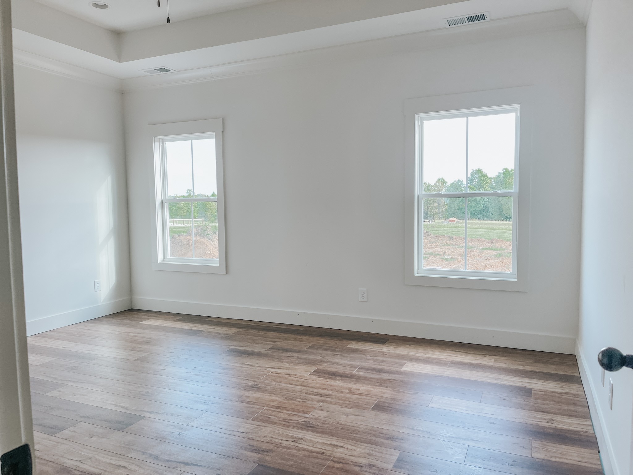 1402 Fowler Ford Road Portland, TN 37148 - Photo 16 of 27 an empty room with wooden floor and windows